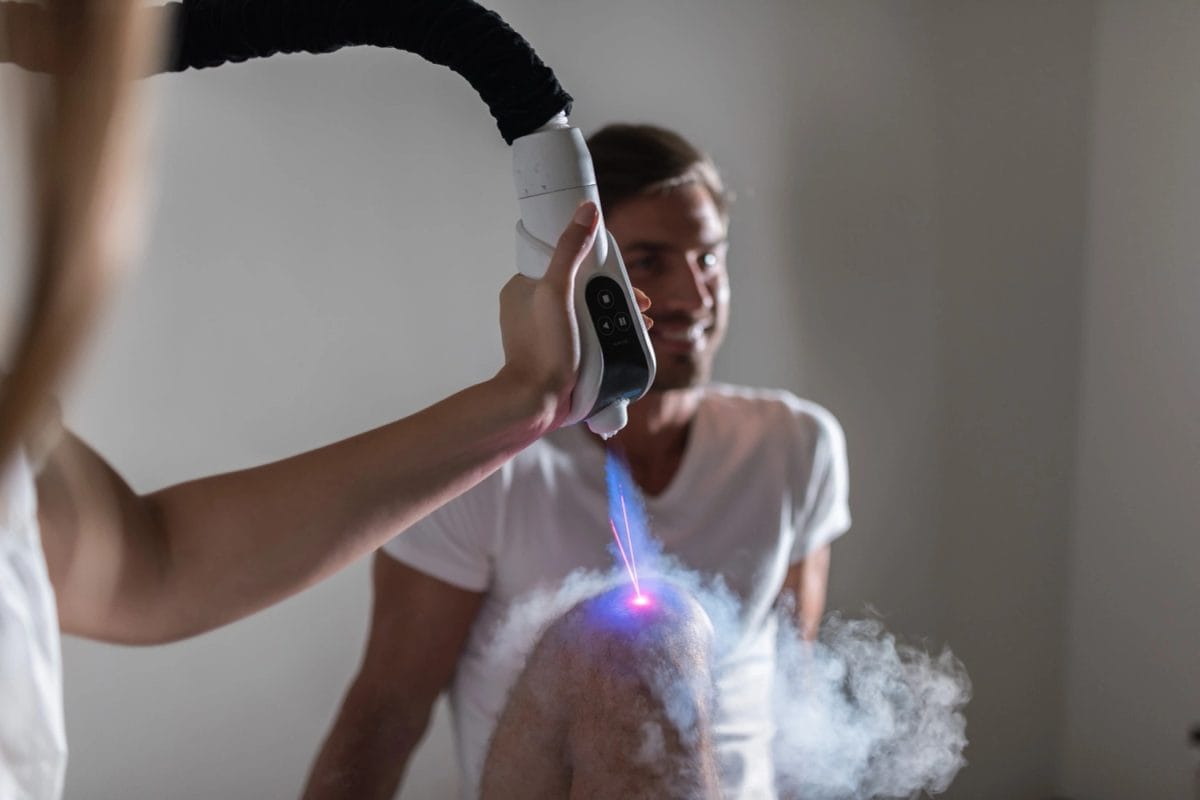 Localized cryotherapy being applied to a client's shoulder